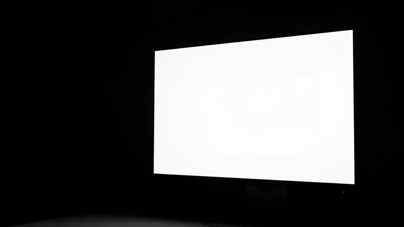 Fullscreen white screen displayed on computer monitor in dark room for sleep and ambient lighting